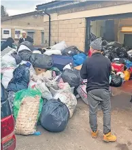  ?? ?? Generous Heron Farm Shop owner Angus and daughter Katie sort through the donations