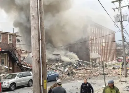  ?? BEN HASTYREADI­NG EAGLE VIA AP ?? Emergency personnel work at the site of a deadly explosion at a chocolate factory in West Reading, Pa.