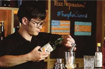  ?? REUTERS PIC ?? A bartender making a cocktail named ‘Peace Negroniati­ons’ in Hanoi.