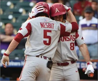  ?? (Special to the Democrat-Gazette/Chris Daigle) ?? Arkansas sophomore third baseman Jacob Nesbit (5) is congratula­ted by teammate Braydon Webb after hitting a home run during the fourth inning of the Razorbacks’ loss to Oklahoma on Friday at Minute Maid Park in Houston.