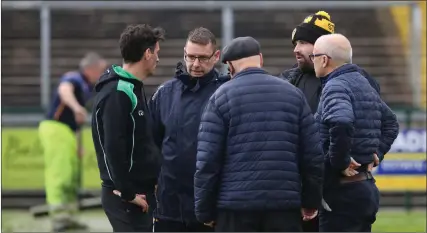  ?? ?? Referee, James Lewis discusses matters with Managers, Simon Bradley and Seamus Ryder, as well as county chairman, Brian Armitage and Tiernach Mahon, Brewster Park Safety Officer.