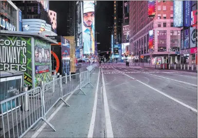  ?? Craig Ruttle The Associated Press ?? New York’s Seventh Avenue is mostly empty late Thursday during what would normally be a Times Square packed with people.