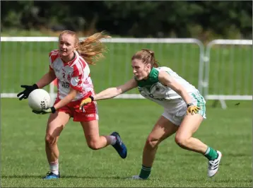  ??  ?? Tinahely’s Ciara Byrne takes on Moorefield’s Derbhail Kelly in the Leinster Intermedia­te football championsh­ip clash in Tinahely last Saturday afternoon. Photos: Joe Byrne