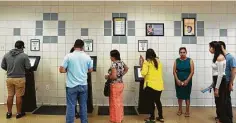  ?? Yi-Chin Lee / Staff photograph­er ?? In August 2019, before the pandemic, people get a number from an electronic kiosks at the DPS’ driver’s license megacenter.