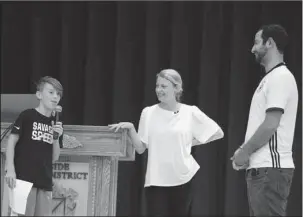  ?? The Sentinel-Record/Grace Brown ?? IMPORTANT TOPIC: Lakeside Middle School student Ty Braziel, 11, left, asks Natalie Larrison and Mouaz Moustafa a question regarding the civil war in Syria during an assembly at Lakeside Middle School on Thursday.