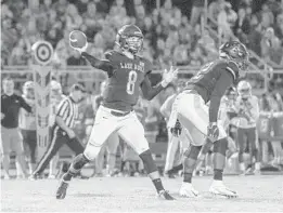  ?? JASON BEEDE/ORLANDO SENTINEL ?? Lake Nona’s Conner Johnson makes a throw in the second quarter Friday at East River.