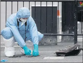  ??  ?? Forensic experts recover the knives spilled from the backpack yesterday