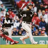  ?? Michael Dwyer / Associated Press ?? The White Sox’s Leury Garcia follows through on a sacrifice fly in the ninth inning on Saturday in Boston.