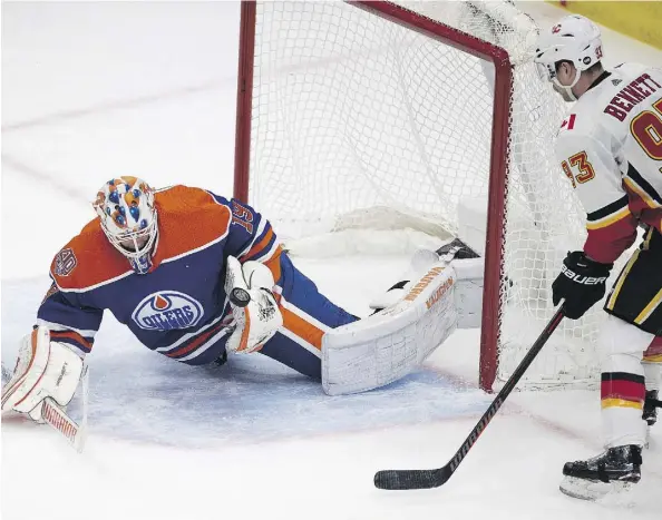  ?? GREG SOUTHAM ?? Edmonton Oilers goaltender Mikko Koskinen makes one of his 24 saves with Calgary Flames forward Sam Bennett on his doorstep during NHL action Sunday at Rogers Place. Koskinen recorded a 1-0 shutout with Connor McDavid scoring the only goal for the Oilers.