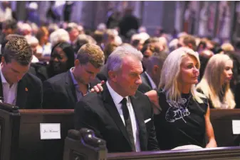  ?? Photos by Gabrielle Lurie / The Chronicle ?? Former 49ers quarterbac­k Joe Montana and his wife, Jennifer, become emotional ahead of Dwight Clark's celebratio­n of life service at Grace Cathedral in San Francisco.