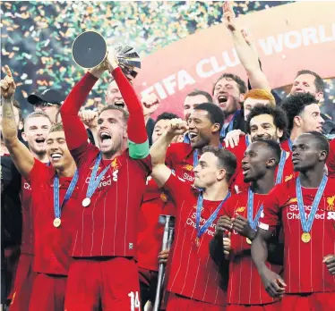  ??  ?? Project uncertain: Liverpool captain Jordan Henderson and his team-mates celebrate winning the Fifa Club World Cup but it’s still unclear when they can realise their Premier League dream