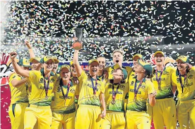  ?? Picture: HARRY TRUMP-IDI/IDI VIA GETTY IMAGES ?? AN UPLIFTING TRIUMP: The Australia team celebrate as Meg Lanning lifts the trophy at the conclusion of the ICC Women’s World T20. They defeated England in the final played at the Sir Vivian Richards Cricket Ground in Antigua on Saturday.