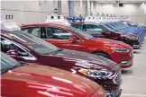  ?? JUSTIN MERRIMAN/BLOOMBERG ?? Argo AI modified Ford Fusion autonomous vehicles sit parked in a garage at the company’s headquarte­rs in Pittsburgh in 2018.