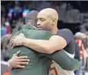  ?? JOHN BAZEMORE/AP ?? Hawks guard Vince Carter, right, hugs former Hawk Dominique Wilkins after a game against the New York Knicks on March 11 in Atlanta.