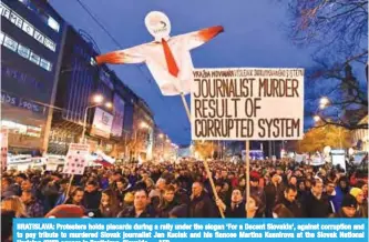  ??  ?? BRATISLAVA: Protesters holds placards during a rally under the slogan ‘For a Decent Slovakia’, against corruption and to pay tribute to murdered Slovak journalist Jan Kuciak and his fiancee Martina Kusnirova at the Slovak National Uprising (SNP) square...