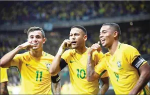  ?? VANDERLEI ALMEIDA/AFP ?? Brazil’s Neymar (centre) celebrates with Philippe Coutinho (left) and Gabriel Jesus after scoring against Argentina in a World Cup qualifier on November 10.