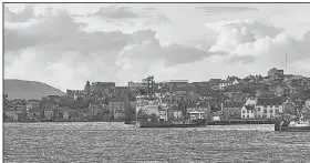  ?? The New York Times/ANDY HASLAM ?? A ferry approaches Lerwick Harbor on Scotland’s Shetland Islands. The islands are not easy to reach, but visitors will find beautiful scenery, friendly locals and a rich culture.