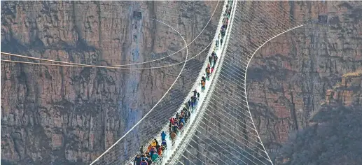  ?? Photo: CNN ?? Test of nerves: Billed as the world’s longest glass-bottomed suspension bridge, this new structure in China’s northeaste­rn Hebei province opened at the end of December 2017.