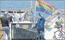  ?? SHERRY LAVARS — MARIN INDEPENDEN­T JOURNAL ?? A worker unloads a section of fencing to be put around a cleared homeless encampment at Dunphy Park in Sausalito on June 29. Those living in the camp were relocated.