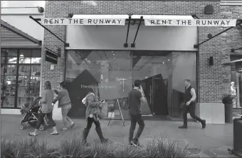  ?? TRIBUNE NEWS SERVICE ?? People walk past the Rent the Runway store located at the Village at Westfield Topanga shopping mall in Woodland Hills.