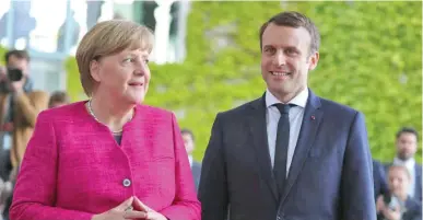  ??  ?? From left; German Chancellor Angela Merkel and French President Emmanuel Macron in Berlin, Germany.