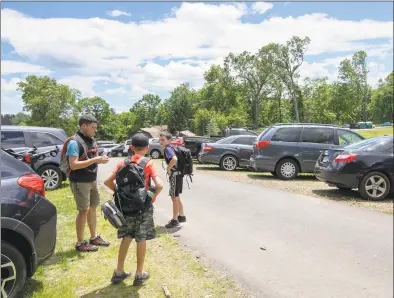  ?? Dave Zajac / Associated Press ?? Brendan Holt, left, and son Ronan, 10, right, along with friend, Max Pugliese, 10, get ready to hike the trails at Sleeping Giant State Park in Hamden on Friday. The park reopened a year after a tornado ravaged the landscape.