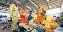  ?? PHOTO: ROBYN EDIE/FAIRFAX NZ 631866565 ?? Southern Rural Firefighte­rs, from left, Grant Tremain, Warren Heslip, Vuniyani Qoro, Neil Gardyne and Napolioni Qasevakati­ni try on gear at the Kingswell Fire Station yesterday.