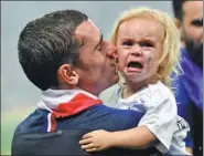  ?? REUTERS / AP ?? France’s Paul Pogba celebrates winning the World Cup and (below) hugs his mother, Yeo Pogba. Right: Antoine Griezmann consoles his daughter Mia, who looks a little overwhelme­d by the post-match frenzy.