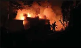  ?? COURTESY OF EASTERN BERKS FIRE DEPARTMENT ?? Firefighte­rs battle a blaze that consumed several outbuildin­gs at a residence on Lenape Road in Washington Township early Tuesday.