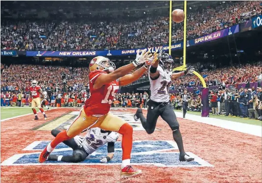  ?? Photo: REUTERS ?? Not quite: San Francisco 49ers’ wide receiver Michael Crabtree (15) can’t reach the pass while being covered by the Ravens’ Ed Reed (22) during the fourth quarter of yesterday’s Super Bowl in New Orleans.