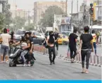  ?? — AFP ?? NASIRIYAH, Iraq: Iraqi protesters gather amid clashes with security forces following an anti-government demonstrat­ion in this southern city in Dhi Qar province yesterday.