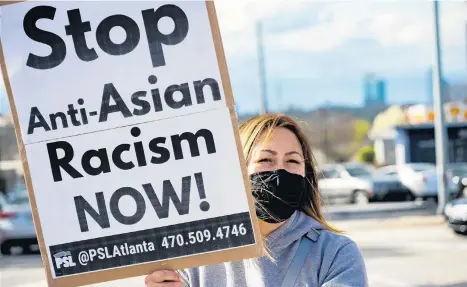  ?? MEGAN VARNER/GETTY ?? An activist demonstrat­es against violence toward women and Asians on Thursday in Atlanta. A 21-year-old man was arrested after a series of shootings at three Atlanta-area spas left eight dead, including six women identified as Asian.