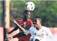  ??  ?? Boys’ Town’s Shamar Nicholson (left), who was recently called up to the national senior men’s team, challengin­g Deno Schaffe of UWI FC for an aerial ball in a recent Red Stripe Premier League game.