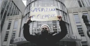  ?? JOHN MINCHILLO AP PHOTO/ ?? A demonstrat­ors holds a sign that reads “GARCIA LUNA ES CULPABLE,” or “GARCIA LUNA IS GUILTY” outside federal court moments before Genaro García Luna was found guilty of taking massive bribes to protect the violent drug cartels he was tasked with combating on Tuesday in New York.