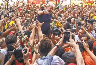  ?? Miguel Schincario­l / AFP / Getty Images ?? Former Brazilian President Luiz Inacio Lula da Silva waves to supporters at the headquarte­rs of a metalworke­rs union in Sao Bernardo do Campo, in metropolit­an Sao Paulo.