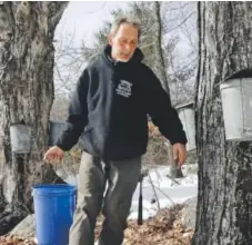  ??  ?? Parker’s Maple Barn employee Jon Jonis carries maple tree sap he gathered from metal buckets Tuesday in Brookline, N.H. Climate change is impacting the industry. Elise Amendola, The Associated Press