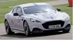  ??  ?? ON TRACK Aston Martin boss Andy Palmer was able to exploit the Rapide E’s 604bhp output on the Stowe Circuit at Silverston­e