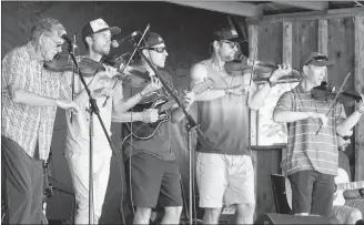  ?? KATHERINE HUNT/THE GUARDIAN ?? The Chaisson Family kicked off the afternoon of entertainm­ent on Saturday at the 2018 Rollo Bay Fiddle Festival. Shown above are, from left, Kenny Chaisson, Tim Chaisson, Elmer Deagle, Darren Chaisson, Stephen Chaisson and Brent Chaisson.