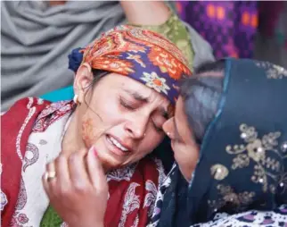  ??  ?? Mother of Indian teenage girl Neelam Devi wails before her funeral in Pindi in Arnia district of Jammu and Kashmir, India, on Thursday. Indian officials say the teenage girl and a soldier have been killed by Pakistani troops firing along the volatile...