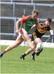  ??  ?? Mid Kerry’s Donnchadh Walsh in full flight and pursued by Kieran O’Leary of Dr Crokes