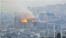  ?? HUBERT HITIER AFP ?? SMOKE and flames rise from a fire that gutted the landmark Notre Dame Cathedral in Paris on April 15, 2019. Five years later, reconstruc­tion is in its final stages. |