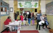  ?? KRISTI GARABRANDT — THE NEWS-HERALD ?? Garfield Elementary School students serve as tour guides as members of the Mentor Schools community come to see the school during the Later Gator Bash on May 4, to say farewell before the school permanentl­y closes.