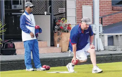  ?? PHOTO: WAYNE PARSONS ?? Skip’s turn . . . Andre Smith, skip of the NelsonMarl­borough Makos men’s four in action during the final of the South Island Open Fours at the Taieri Bowling Club yesterday. Looking on is opposing skip Joko Susilo (Andersons Bay). The Makos defeated Andersons Bay 2613 to win the title.