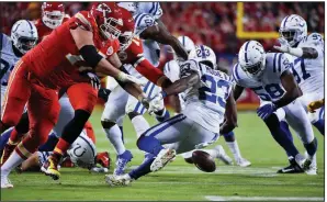  ?? AP/ED ZURGA ?? Indianapol­is Colts cornerback Kenny Moore II (23) and linebacker Bobby Okereke (58) move in to recover the ball after safety George Odum (Central Arkansas) stripped it from Kansas City Chiefs running back LeSean McCoy during the first half Sunday in Kansas City, Mo. The Colts won 19-13, giving the Chiefs their first loss of the season.