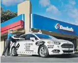  ??  ?? Dominos Pizza is interested in how autonomous­vehicle technology can be applied to its business model, although this Ford Fusion test vehicle has a driver.