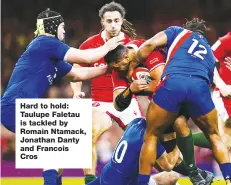  ?? ?? Hard to hold: Taulupe Faletau is tackled by Romain Ntamack, Jonathan Danty and Francois Cros