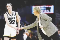  ?? MORRY GASH/AP ?? IOWA GUARD CAITLIN CLARK (22) reacts with head coach
Lisa Bluder during the second half of a Final Four game against Uconn in the women’s NCAA Tournament on Friday in Cleveland.