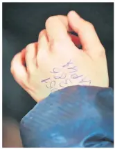  ?? ?? Hassan, 11, at a refugee centre in Slovakia after he fled from his home in Zaporizhzh­ia, Ukraine and travelled 750 miles alone with just the phone number of relatives in the Slovak capital Bratislava written on his hand, above