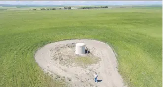  ?? MIKE DREW ?? Lana Bulger stands near a gas well on her farm northwest of Nanton on Thursday.