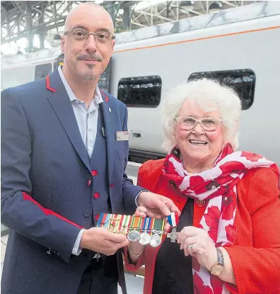  ??  ?? Rita Armin, with husband Henry’s war medals, and Wayne McDonald who found her grandfathe­r’s grave Private Thomas Bryan’s grave visited by Mr McDonald